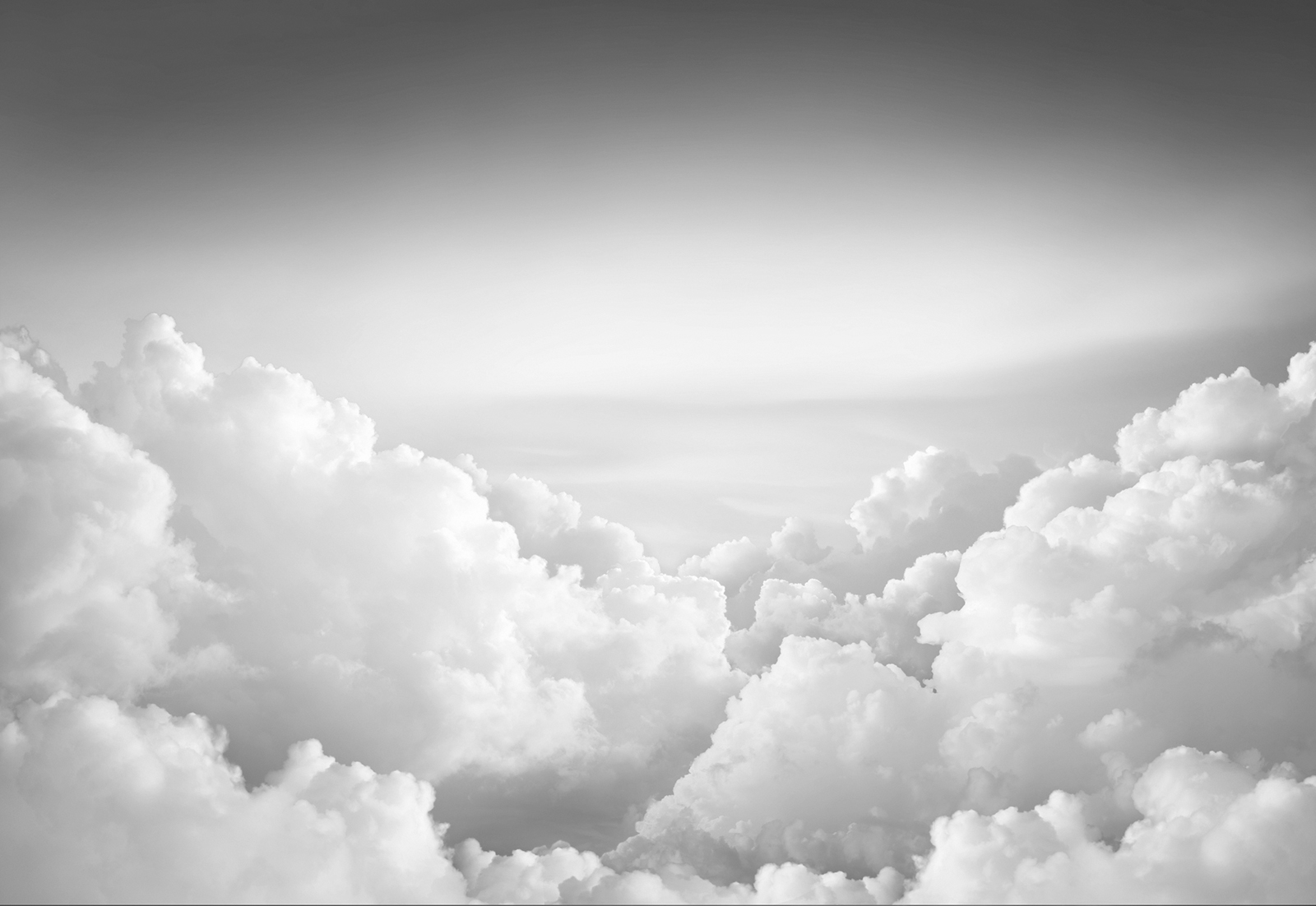 black and white sky with fluffy clouds
